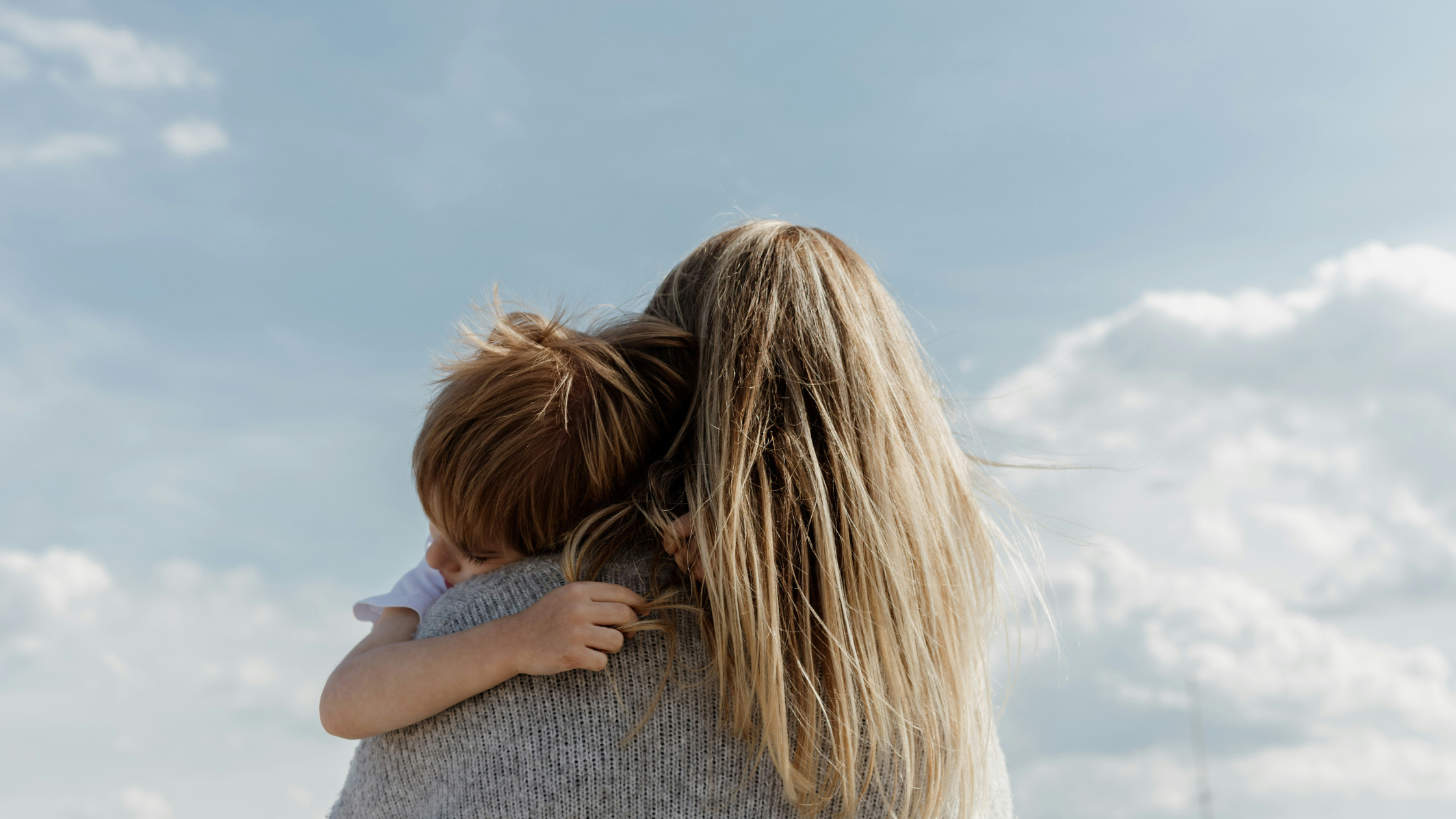 A mother embracing her young son, capturing the precious moments of motherhood and the emotional reward of choosing to stay home with children.